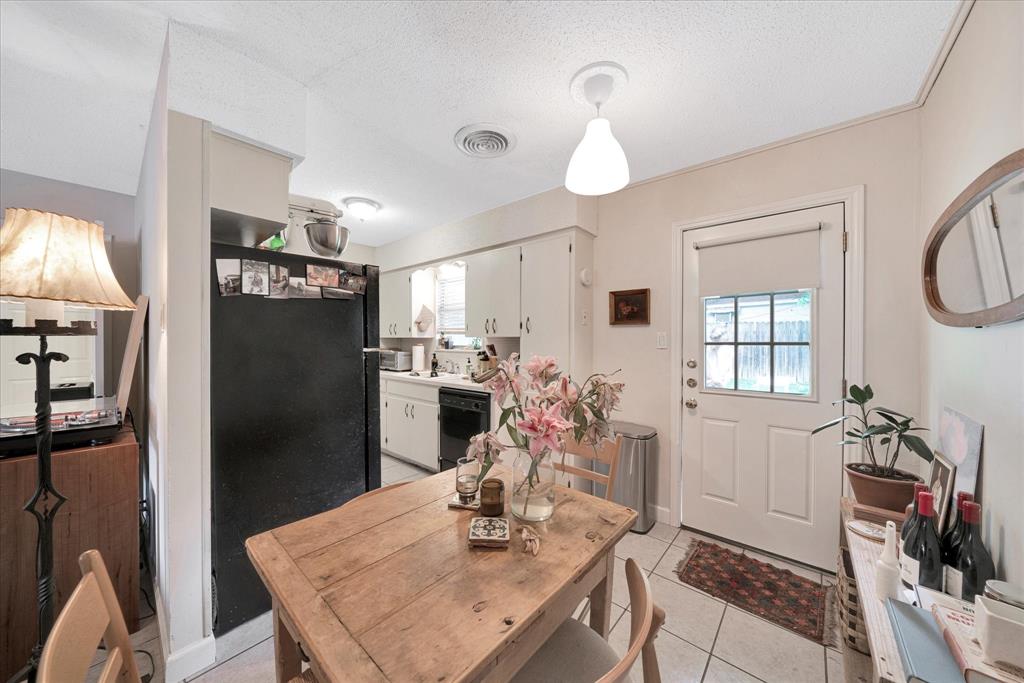 1104 Kinney Avenue, Unit B Austin, TX 78704 - Photo 7 of 14 a kitchen with a refrigerator a stove a sink dishwasher a dining table and chairs with wooden floor