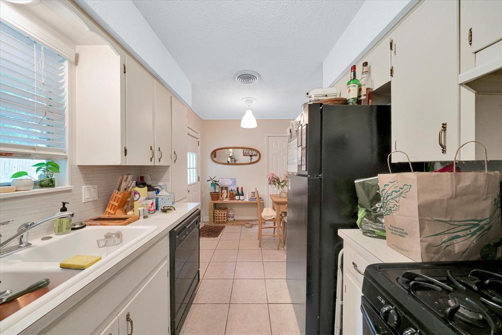1104 Kinney Avenue, Unit B Austin, TX 78704 - Photo 8 of 14 a kitchen with stainless steel appliances granite countertop a refrigerator and a sink