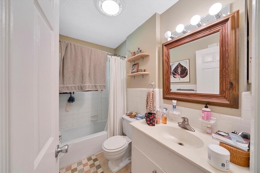 1104 Kinney Avenue, Unit B Austin, TX 78704 - Photo 10 of 14 a bathroom with a sink toilet and shower