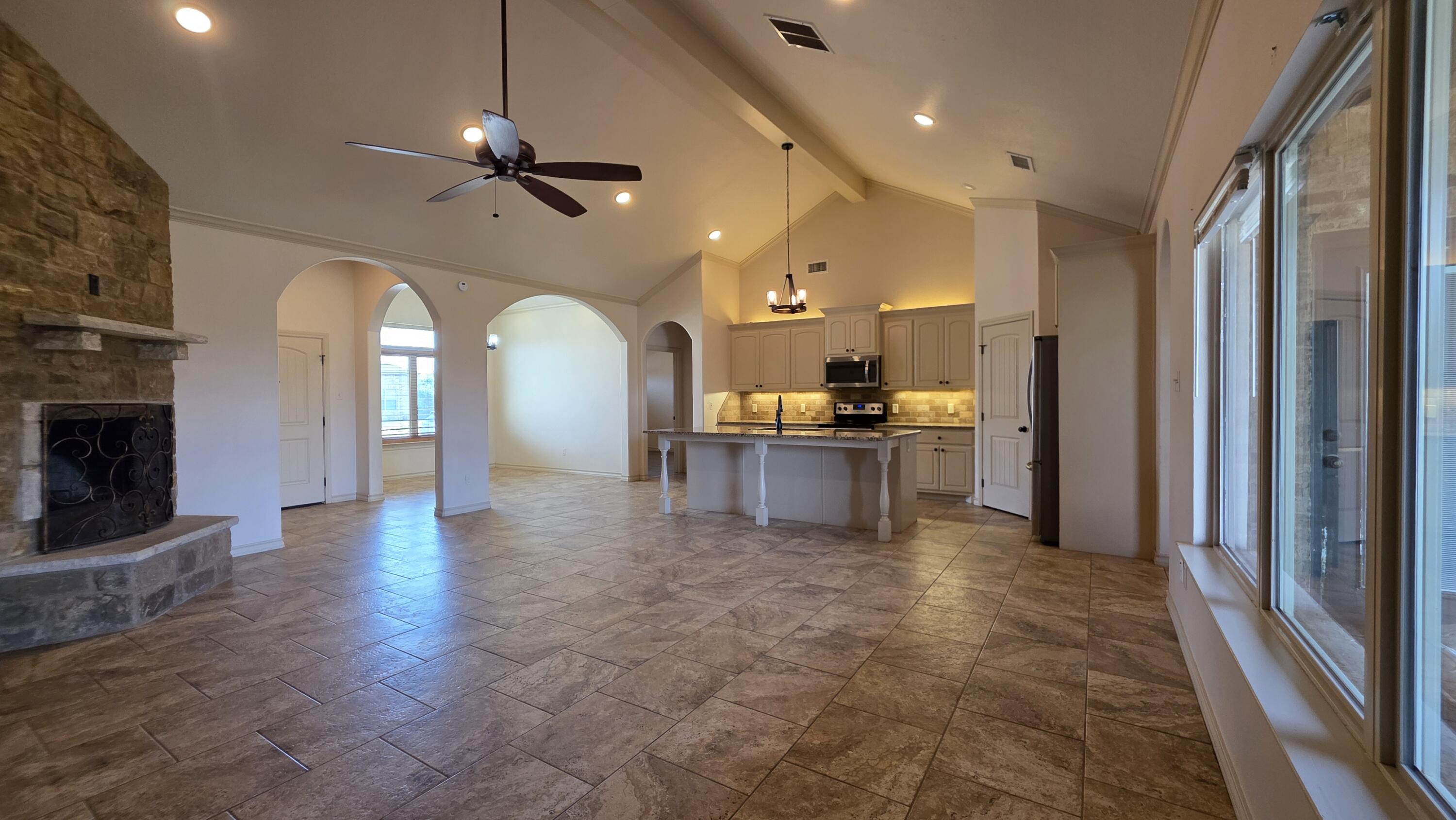 5234 Kemper Street Lubbock, TX 79416 - Photo 5 of 28 a view of a kitchen with a sink and a fireplace