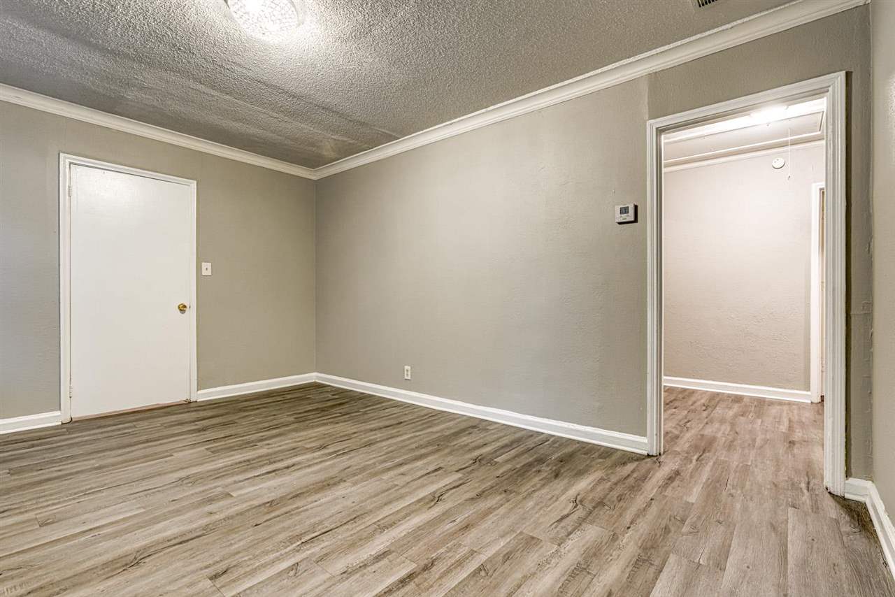 1023 Parkland Road Memphis, TN 38111 - Photo 11 of 22 a view of an empty room with wooden floor