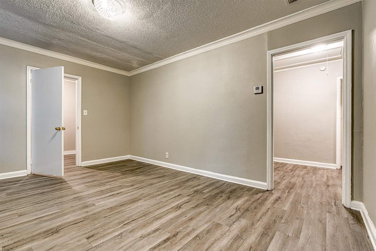 1023 Parkland Road Memphis, TN 38111 - Photo 12 of 22 a view of an empty room with wooden floor and a window
