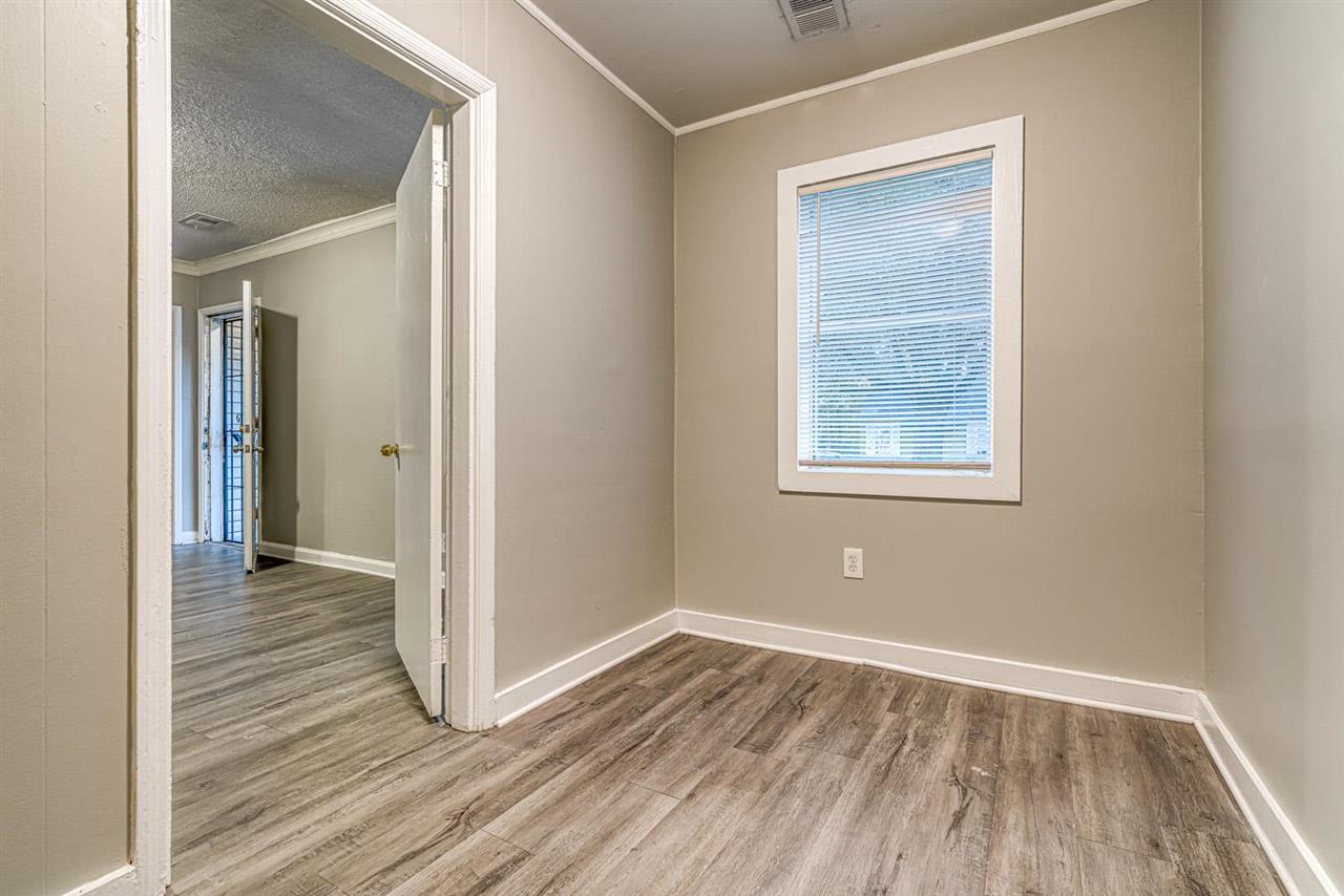 1023 Parkland Road Memphis, TN 38111 - Photo 15 of 22 an empty room with wooden floor and a window