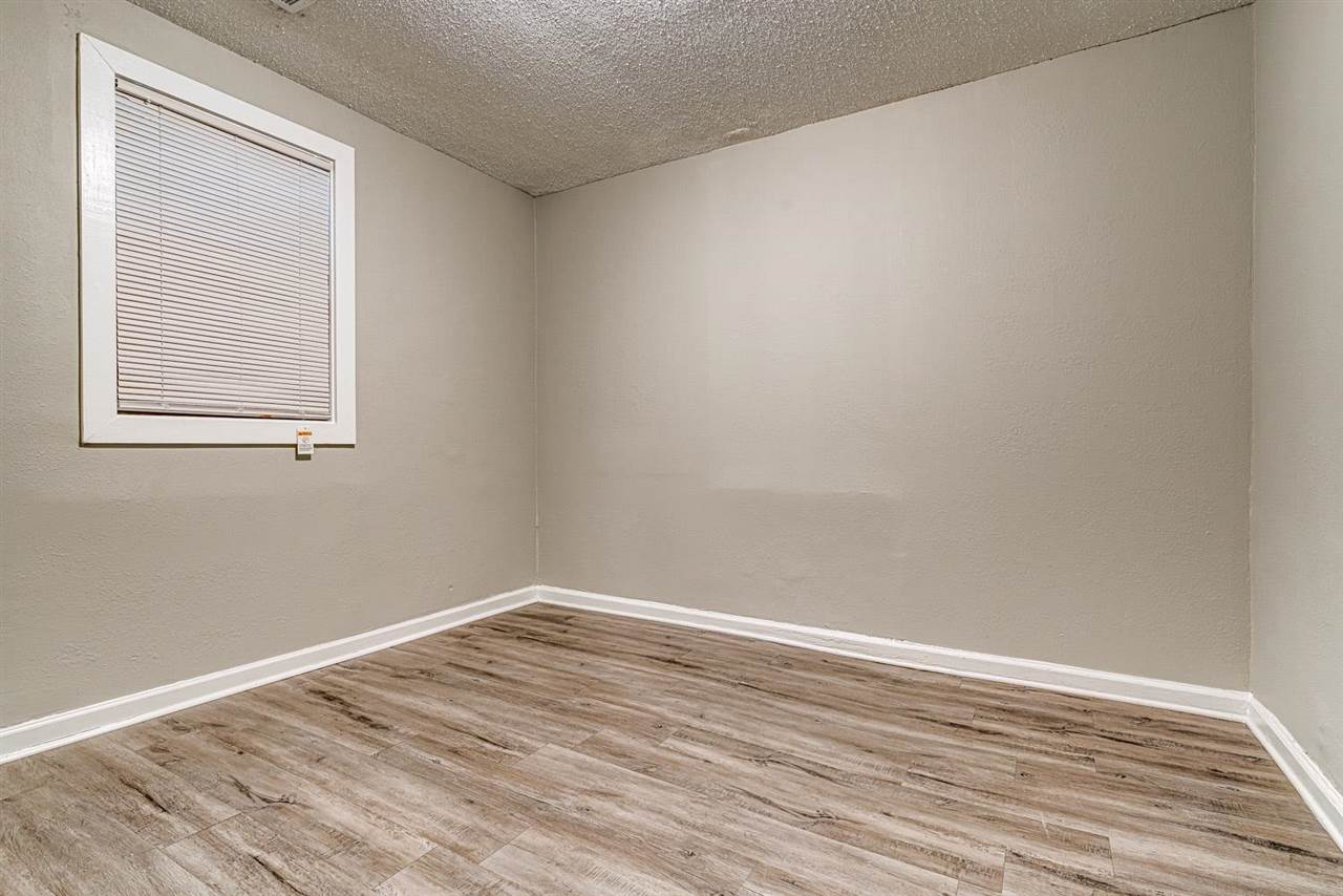 1023 Parkland Road Memphis, TN 38111 - Photo 17 of 22 wooden floor in an empty room with a window