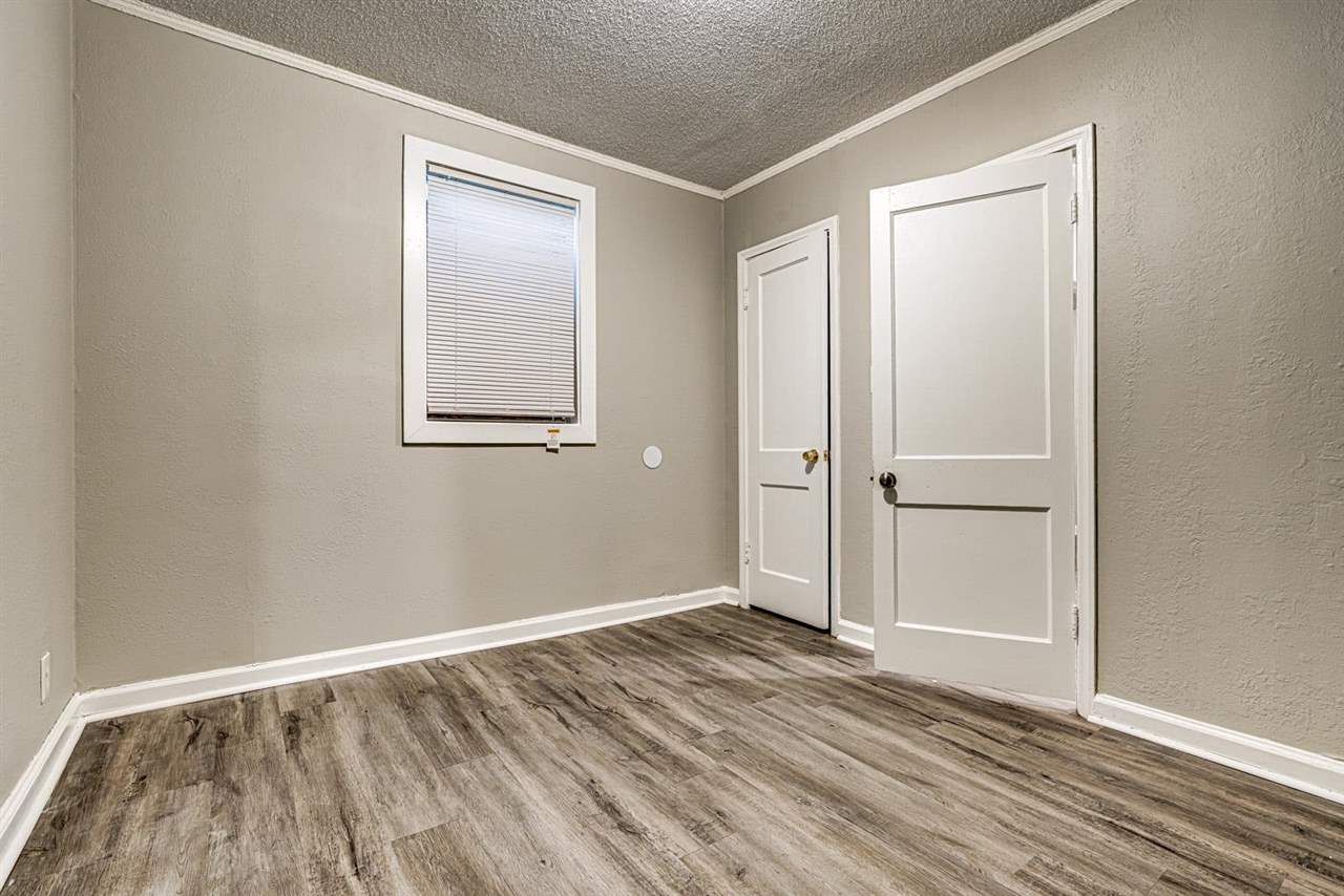 1023 Parkland Road Memphis, TN 38111 - Photo 18 of 22 an empty room with wooden floor and windows