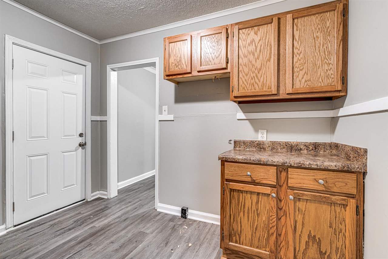 1023 Parkland Road Memphis, TN 38111 - Photo 7 of 22 an entryway with wooden floor and cabinet