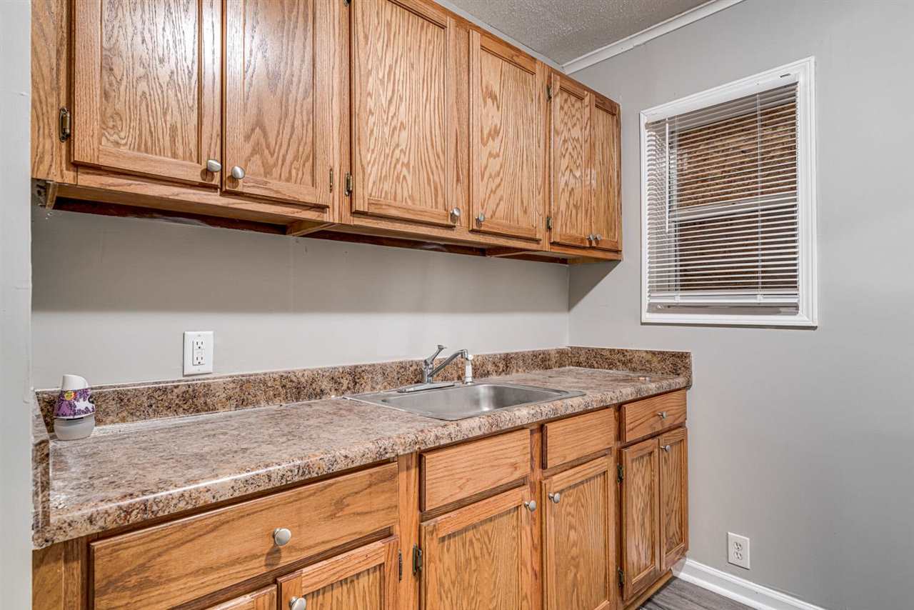 1023 Parkland Road Memphis, TN 38111 - Photo 8 of 22 a kitchen with granite countertop stainless steel appliances sink and cabinets