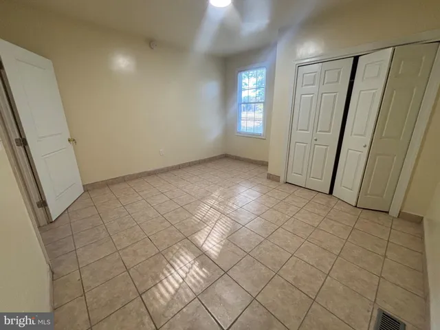 a view of an empty room and a window