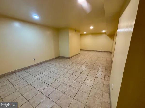 a bathroom with a sink a toilet a mirror and shower