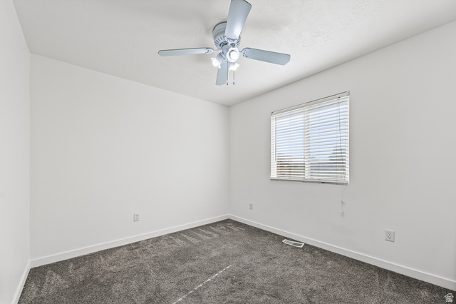 5525 Hampton Way Stansbury Park, UT 84074 - Photo 13 of 35 Carpeted room featuring a ceiling fan with integrated lighting, a single window with blinds, and white painted walls