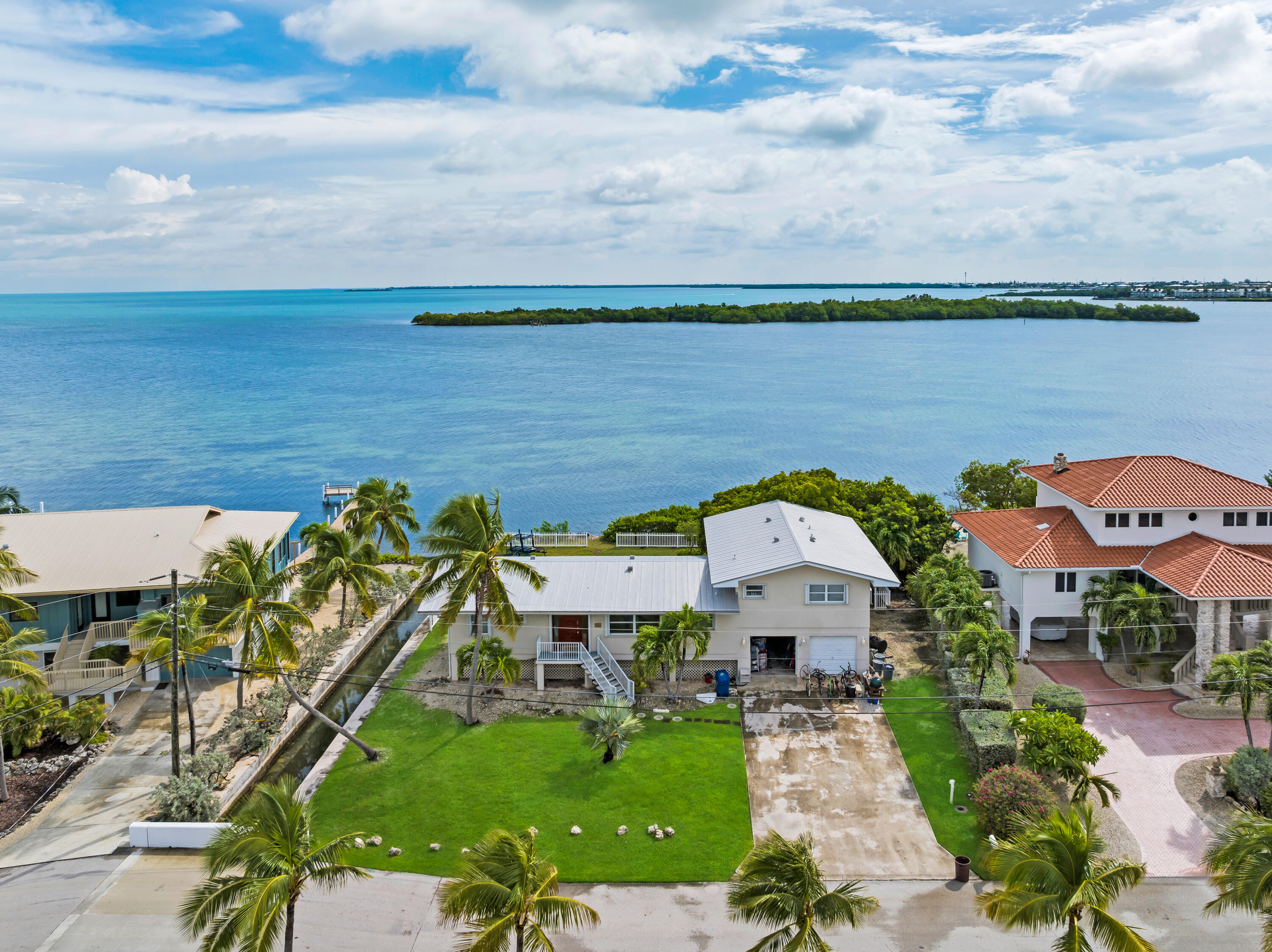 351 Stirrup Key Boulevard Marathon, FL 33050 - Photo 9 of 21 a view of a lake with a big yard and potted plants