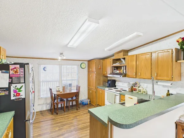 a kitchen with stainless steel appliances granite countertop a sink and cabinets