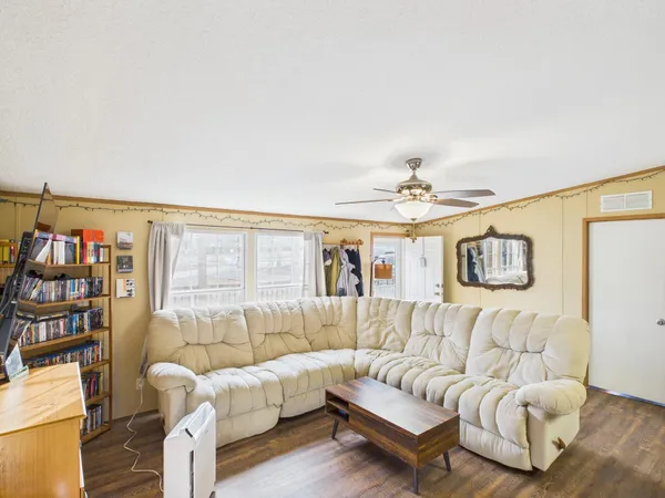 a living room with furniture and a book shelf