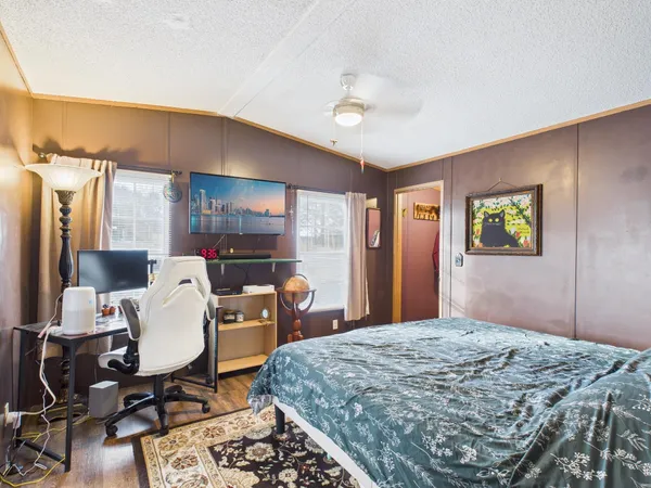 a bedroom with a bed a desk and chair
