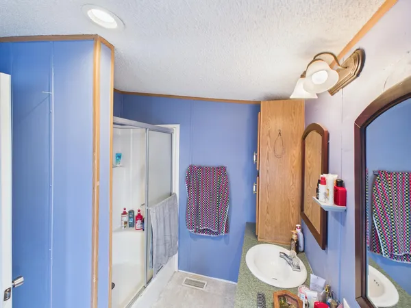 a bathroom with a sink a toilet and shower curtain