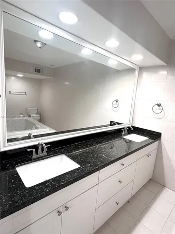 a kitchen with a sink and a white cabinets