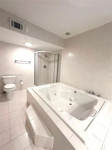 a bath tub sitting next to a white toilet