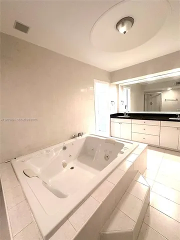 a bath tub sitting in a bathroom next to a sink