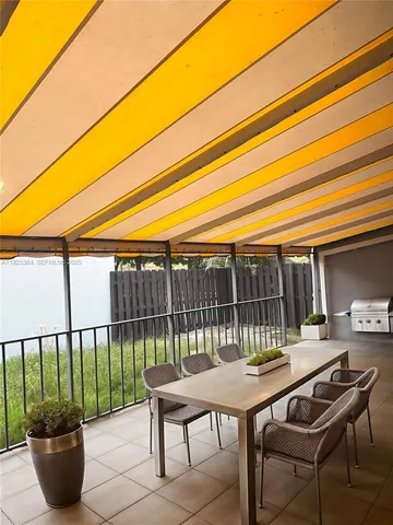 a view of a patio with a table and chairs