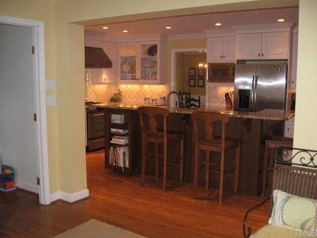 901 Tyrrell Road Raleigh, NC 27609 - Photo 3 of 12 a kitchen with stainless steel appliances kitchen island granite countertop a refrigerator and cabinets
