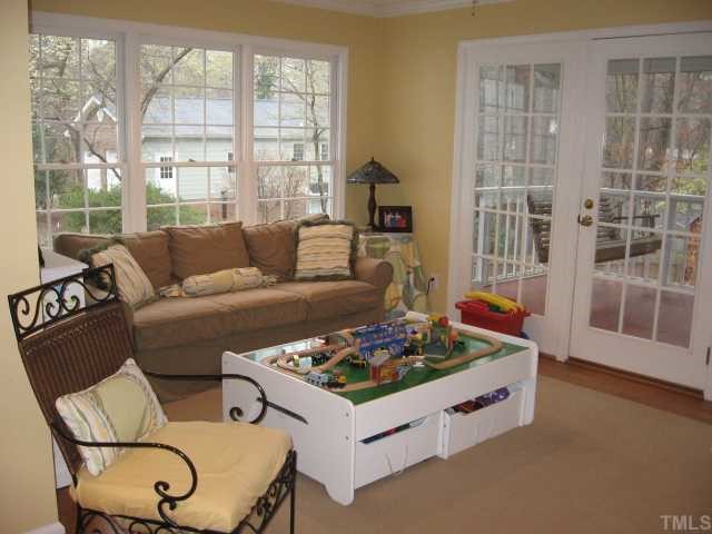 901 Tyrrell Road Raleigh, NC 27609 - Photo 6 of 12 a living room with furniture and a floor to ceiling window