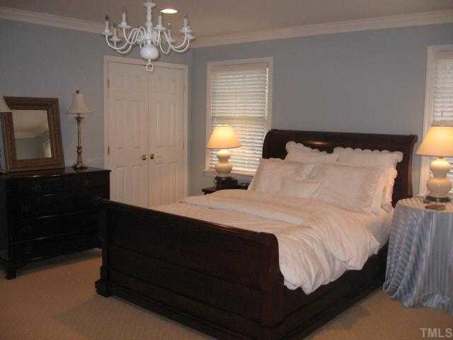 901 Tyrrell Road Raleigh, NC 27609 - Photo 7 of 12 a bedroom with a bed and a dresser