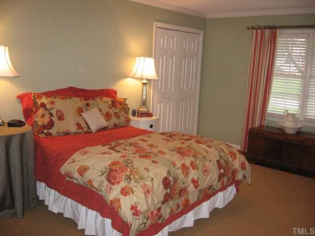901 Tyrrell Road Raleigh, NC 27609 - Photo 8 of 12 a bedroom with a bed and a window