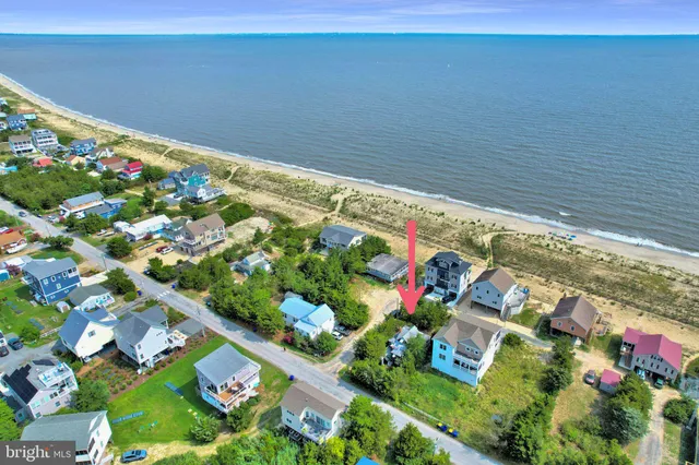 an aerial view of a house with a swimming pool outdoor seating and yard
