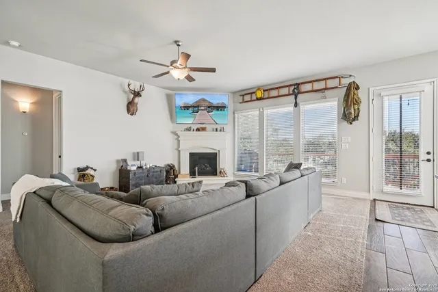 a living room with furniture fireplace and a large window
