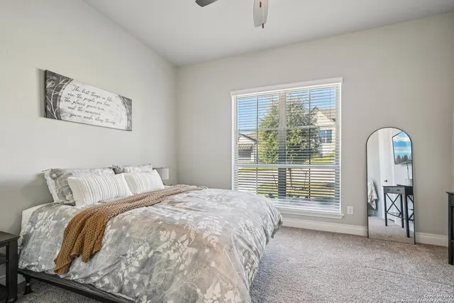 a bedroom with a bed and a large window