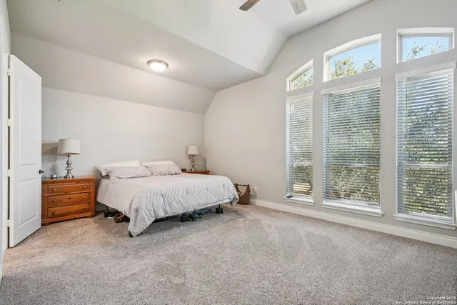 a spacious bedroom with a bed and a large window