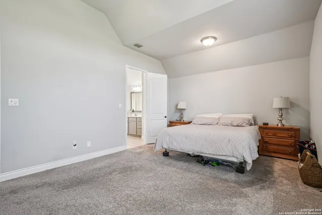 a spacious bedroom with a bed and a window