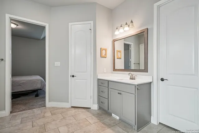 a bathroom with a sink and a mirror