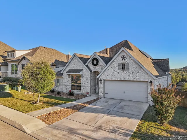 a view of a house with a yard and garage