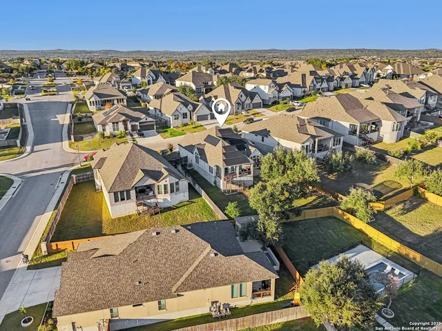 an aerial view of residential houses with outdoor space