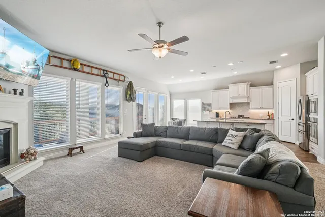 a living room with furniture and a large window