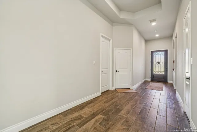 a view of hallway with wooden floor