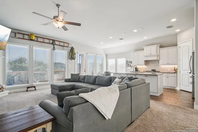 a living room with furniture and a large window
