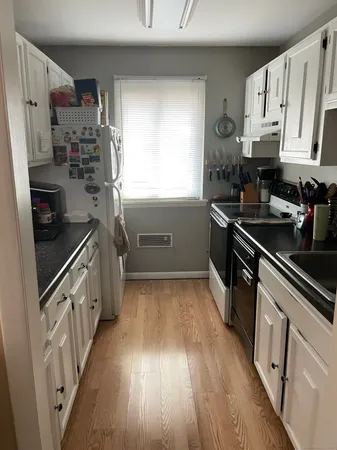 a kitchen with stainless steel appliances a sink dishwasher stove and cabinets