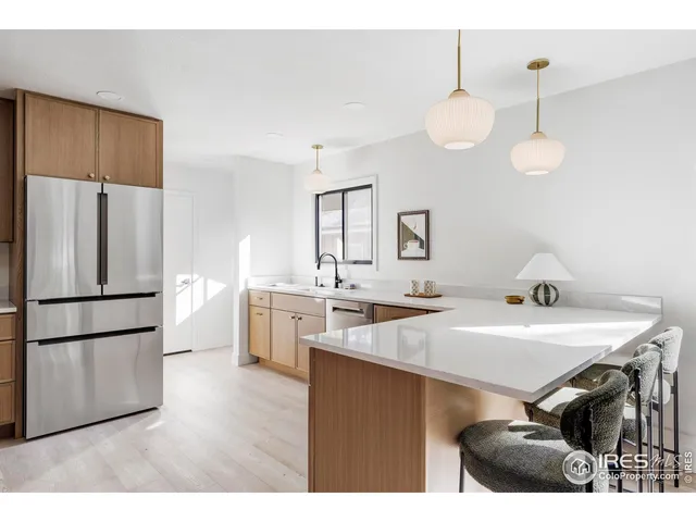 a kitchen with a table chairs refrigerator and microwave