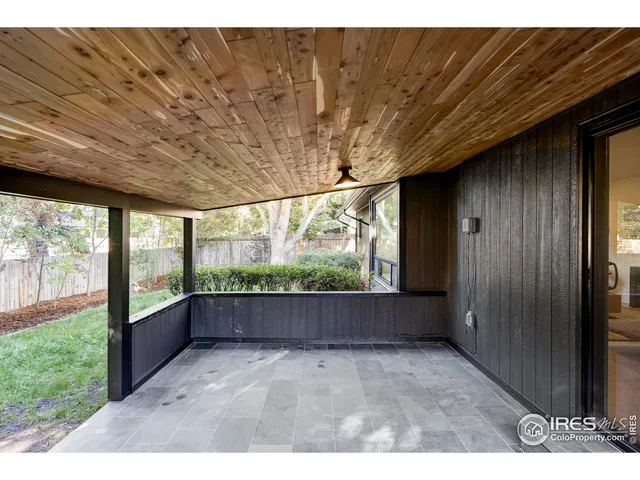 a view of backyard of house with green space