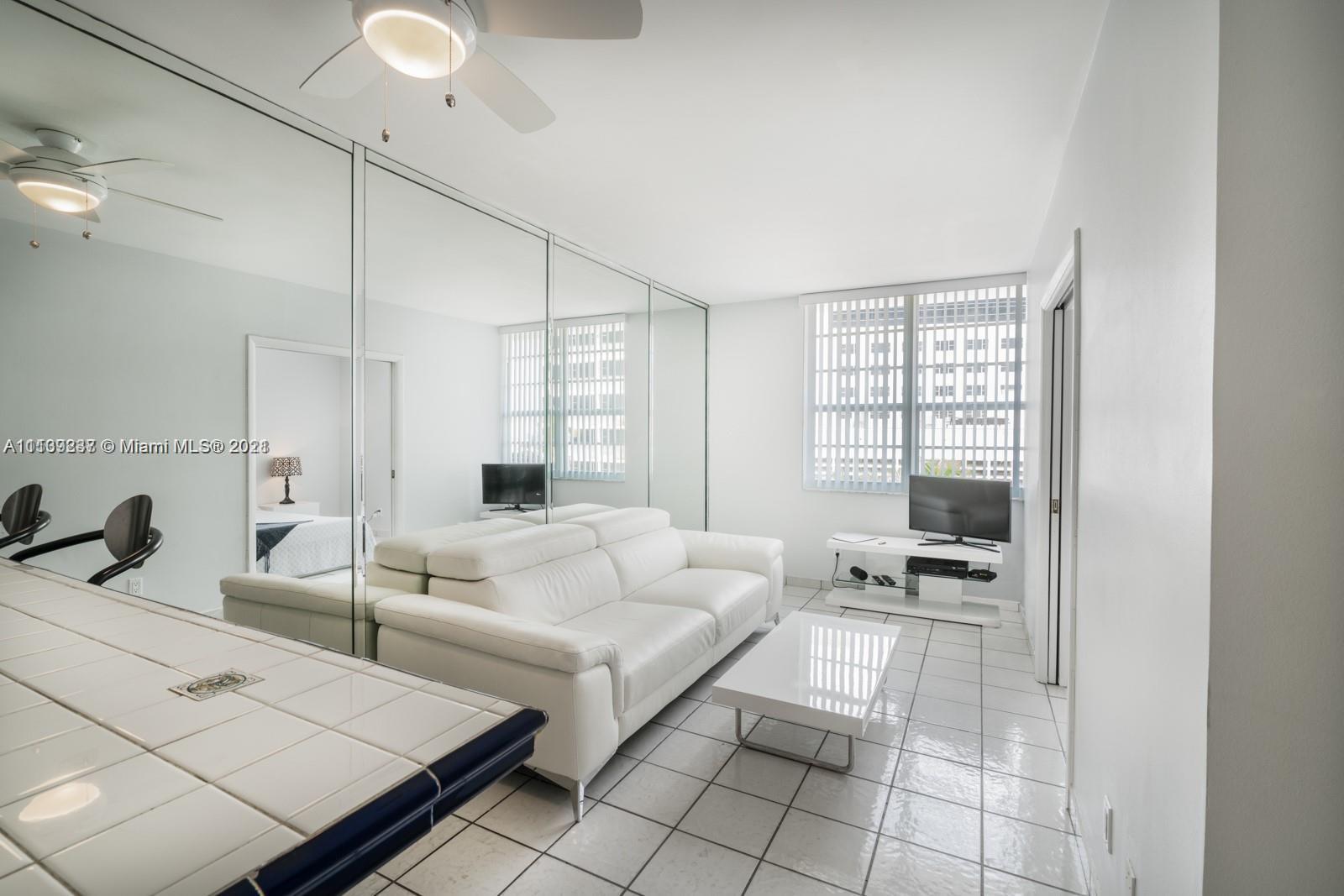 100 Lincoln Road, Unit 406 Miami Beach, FL 33139 - Photo 5 of 10 a living room with furniture and a flat screen tv
