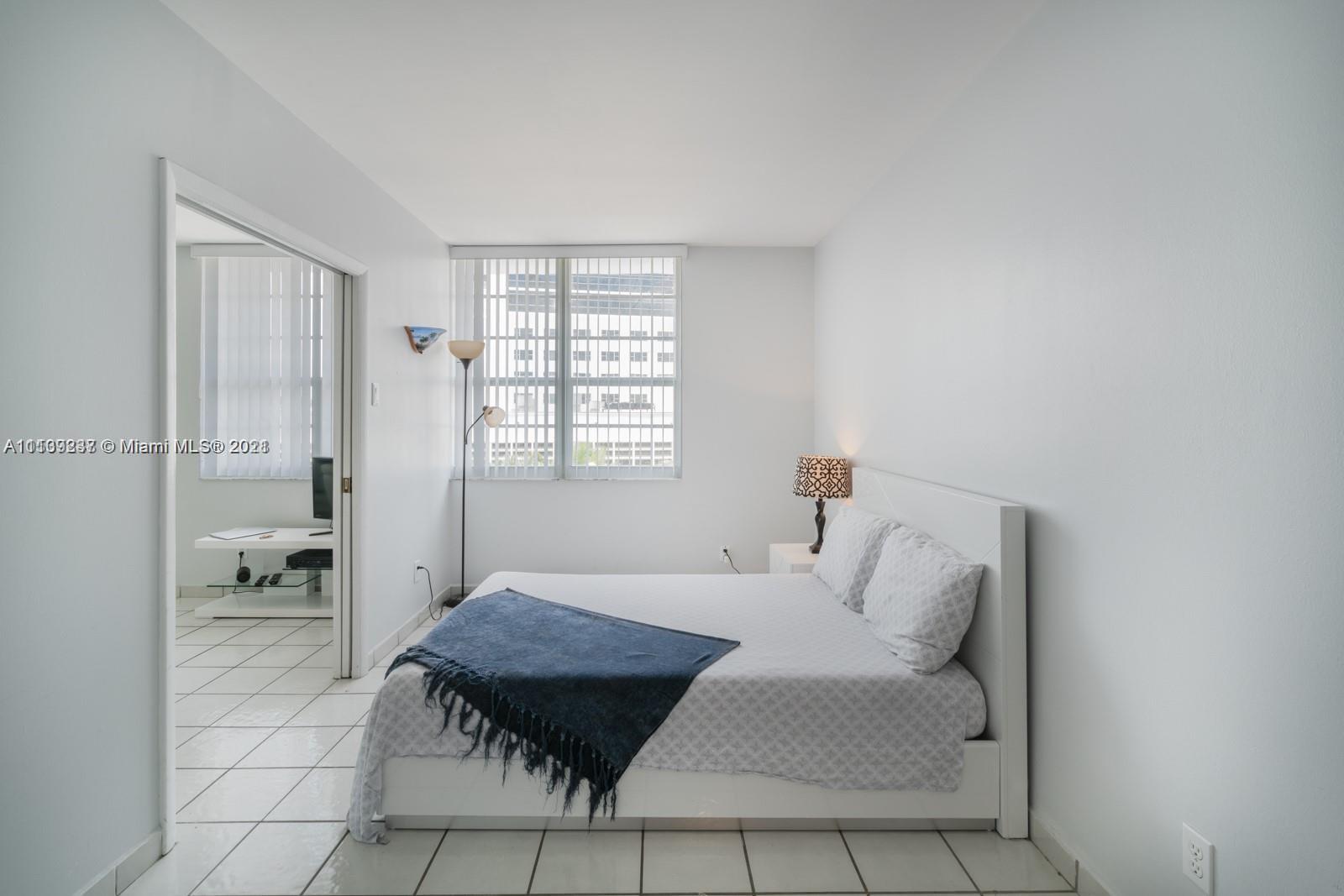 100 Lincoln Road, Unit 406 Miami Beach, FL 33139 - Photo 8 of 10 a living room with furniture and a table