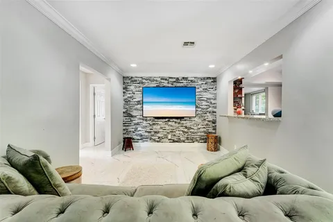 a living room with furniture window and a flat screen tv