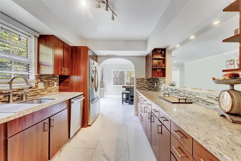 a large kitchen with a sink and cabinets