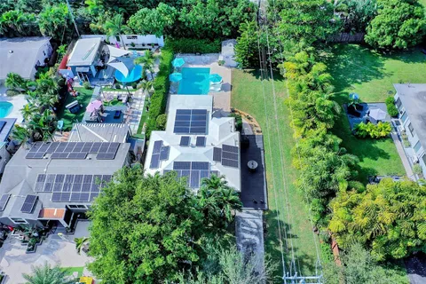 an aerial view of a house with a yard and garden