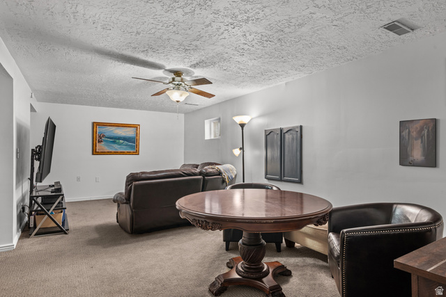 7659 State Street Midvale, UT 84047 - Photo 20 of 33 Spacious room featuring neutral carpeting, light-colored walls, and a textured ceiling