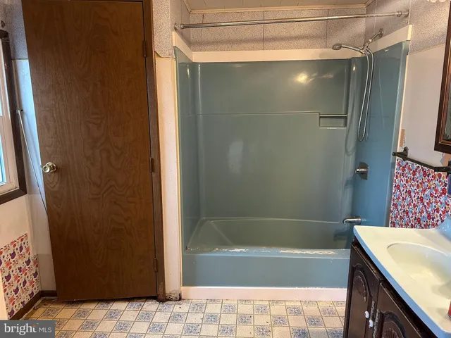 a bathroom with a shower and a bath tub