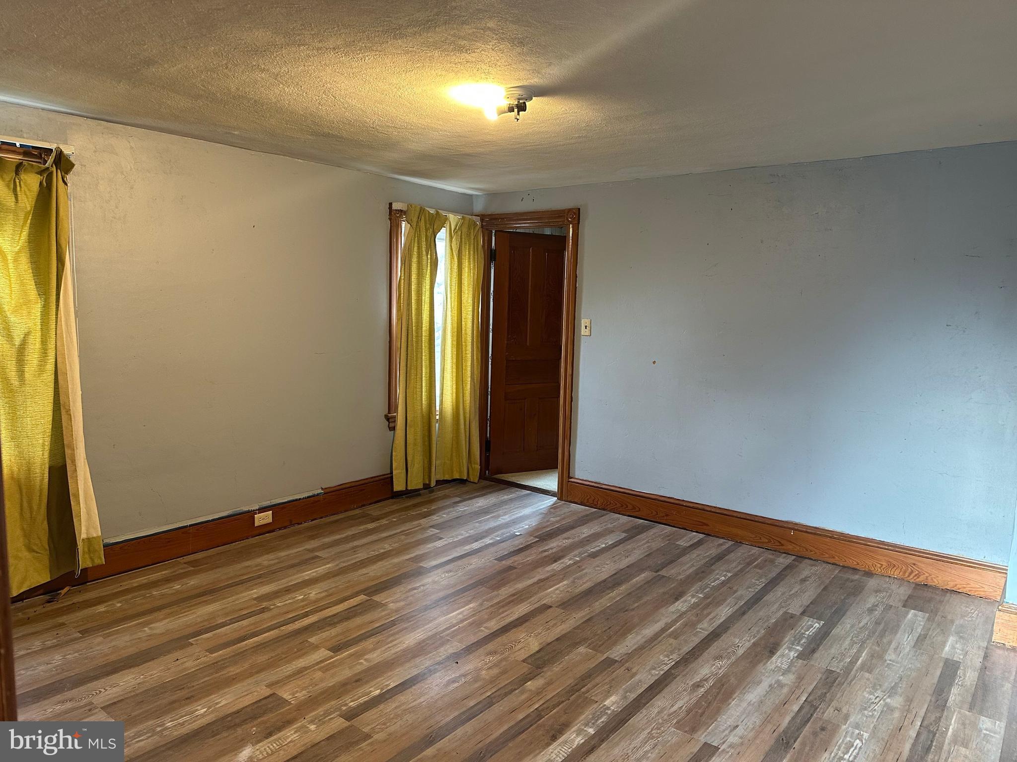4847 Homeville Road Cochranville, PA 19330 - Photo 19 of 36 an empty room with wooden floor and windows