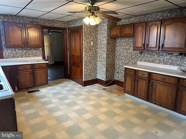 a large kitchen with cabinets and stainless steel appliances